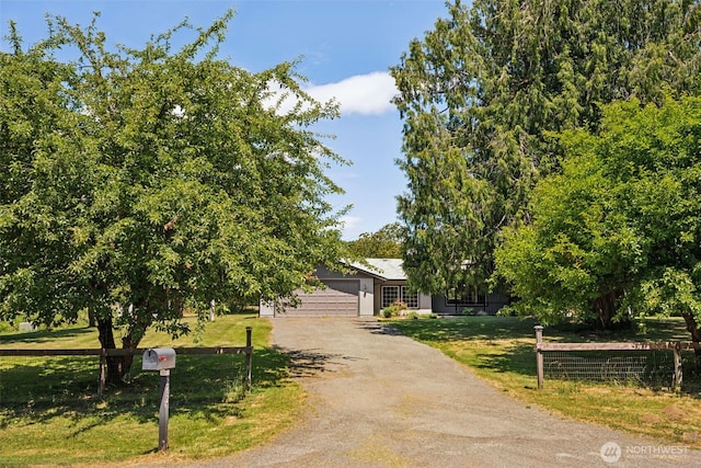 262 Falls Rd, Randle, WA 98377 - obstructed view of property featuring driveway and a garage