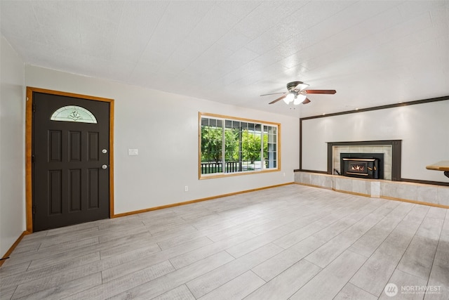 262 Falls Rd, Randle, WA 98377 - unfurnished living room with a ceiling fan, light wood finished floors, and a tile fireplace