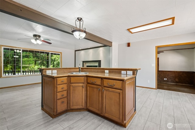262 Falls Rd, Randle, WA 98377 - kitchen with brown cabinets, light wood-type flooring, a fireplace, and ceiling fan