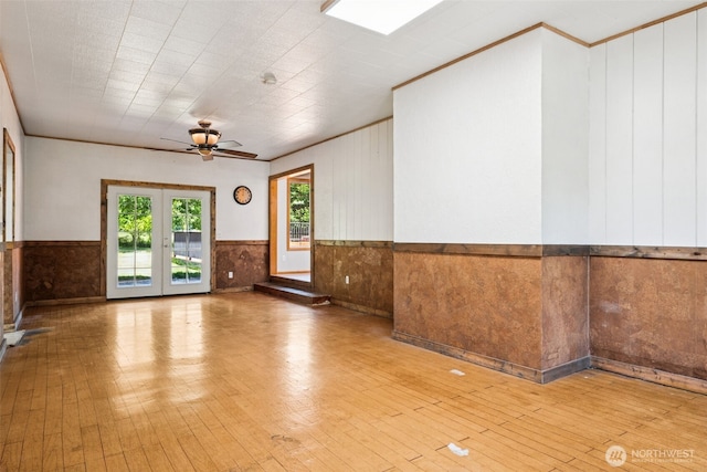 262 Falls Rd, Randle, WA 98377 - spare room featuring a wainscoted wall, hardwood / wood-style flooring, ceiling fan, french doors, and wooden walls