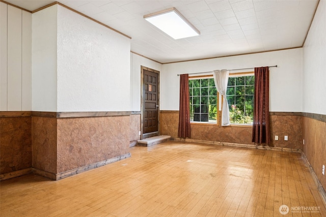 262 Falls Rd, Randle, WA 98377 - unfurnished room with wood-type flooring, wainscoting, and crown molding