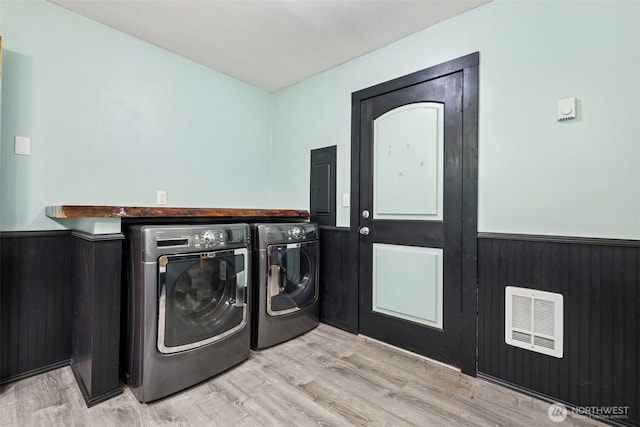 262 Falls Rd, Randle, WA 98377 - washroom featuring washer and dryer, electric panel, a wainscoted wall, and wood finished floors