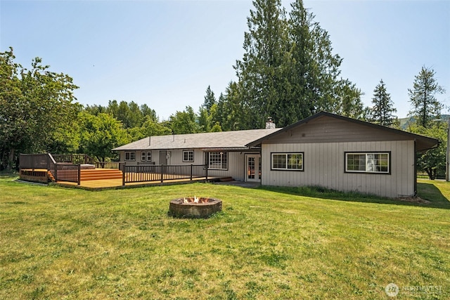 262 Falls Rd, Randle, WA 98377 - back of property featuring a fire pit, a wooden deck, french doors, and a lawn