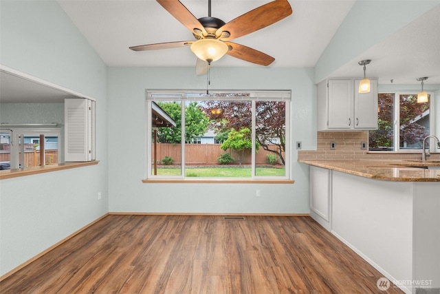 5411 Komachin Loop SE, Lacey, WA 98513 - kitchen featuring wood finished floors, healthy amount of natural light, white cabinets, and light stone counters