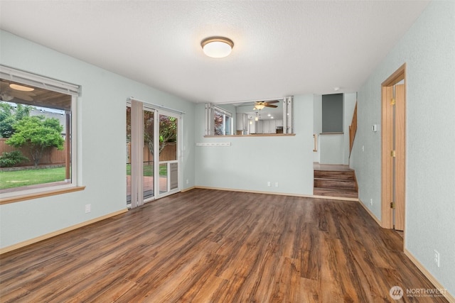 5411 Komachin Loop SE, Lacey, WA 98513 - unfurnished living room featuring healthy amount of natural light, wood finished floors, a ceiling fan, and stairway