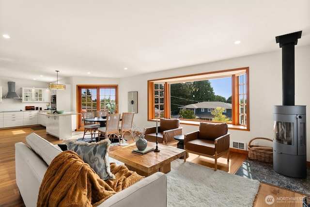 12238 9th Ave NW, Seattle, WA 98177 - living area featuring light wood-style flooring, recessed lighting, and a wood stove