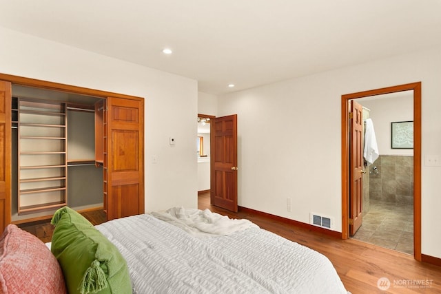 12238 9th Ave NW, Seattle, WA 98177 - bedroom featuring wood finished floors, a spacious closet, recessed lighting, a closet, and connected bathroom