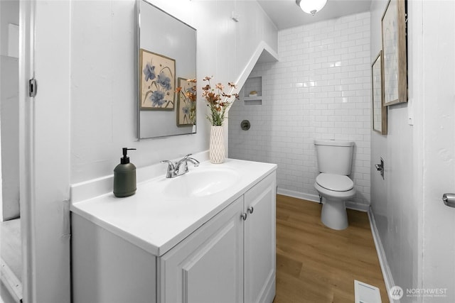 1103 E 59th St, Tacoma, WA 98404 - bathroom with wood finished floors, vanity, and tile walls