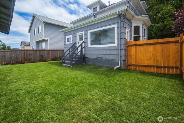 1103 E 59th St, Tacoma, WA 98404 - back of property featuring entry steps and a fenced backyard