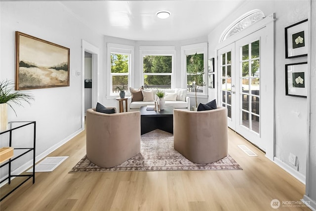 1103 E 59th St, Tacoma, WA 98404 - living area featuring light wood finished floors, healthy amount of natural light, and french doors