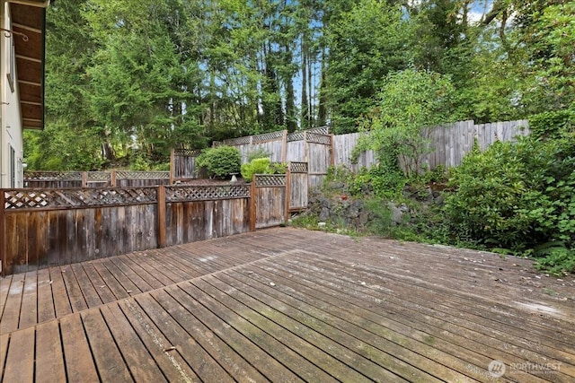 7634 Shilohwood Pl NW, Bremerton, WA 98311 - wooden deck featuring a fenced backyard and view of wooded area