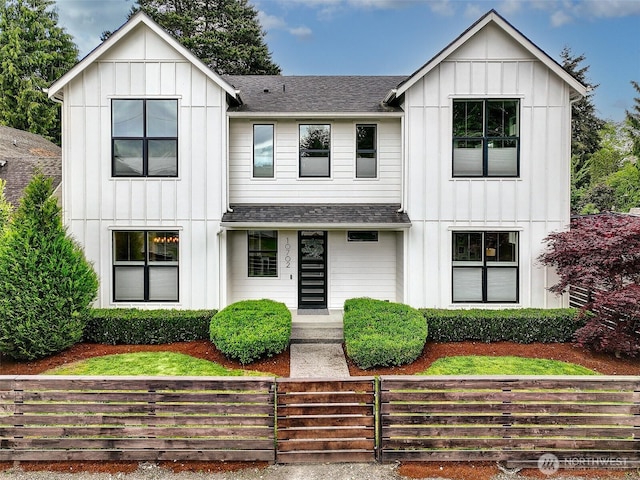 10702 39th Ave NE, Seattle, WA 98125 - modern farmhouse style home with board and batten siding, a shingled roof, and a fenced front yard