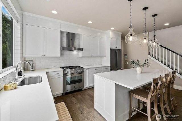 10702 39th Ave NE, Seattle, WA 98125 - kitchen featuring wall chimney exhaust hood, high quality appliances, decorative backsplash, a center island, and dark wood finished floors