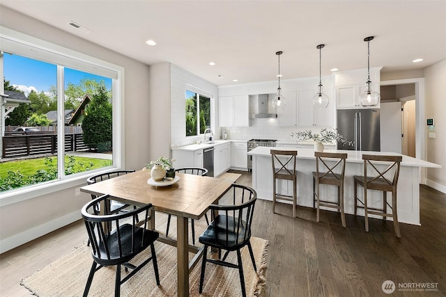 10702 39th Ave NE, Seattle, WA 98125 - dining space with wood finished floors and recessed lighting
