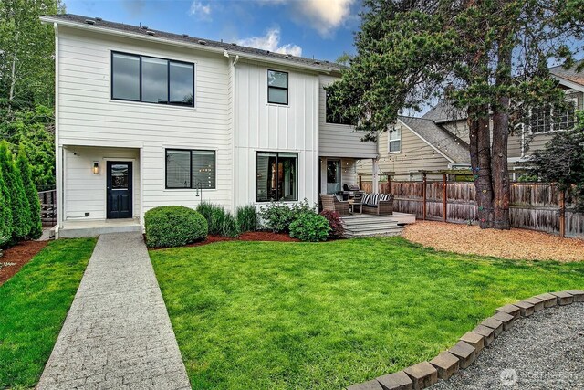 10702 39th Ave NE, Seattle, WA 98125 - back of house with an outdoor hangout area, board and batten siding, and a patio area