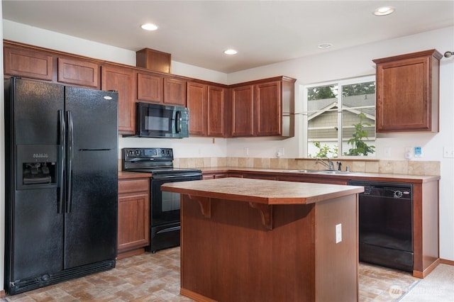 20614 6th Avenue Ct E, Spanaway, WA 98387 - kitchen with black appliances, a center island, light countertops, recessed lighting, and a kitchen bar