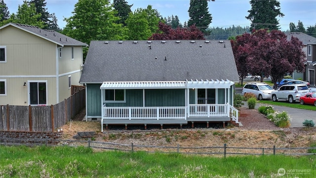 20614 6th Avenue Ct E, Spanaway, WA 98387 - back of house with roof with shingles, a pergola, and board and batten siding
