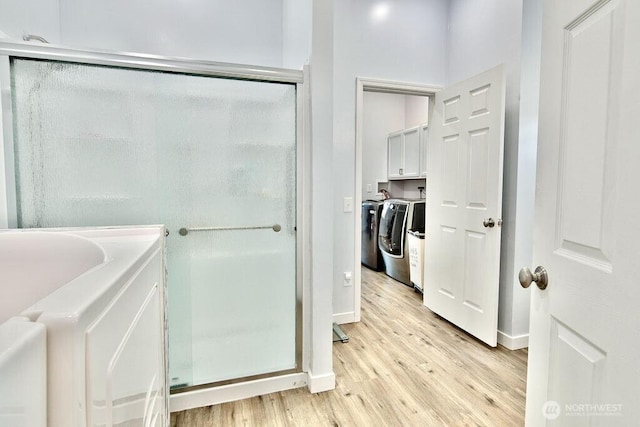 132 Milky Way, Sequim, WA 98382 - bathroom with wood finished floors, a stall shower, separate washer and dryer, and a bath