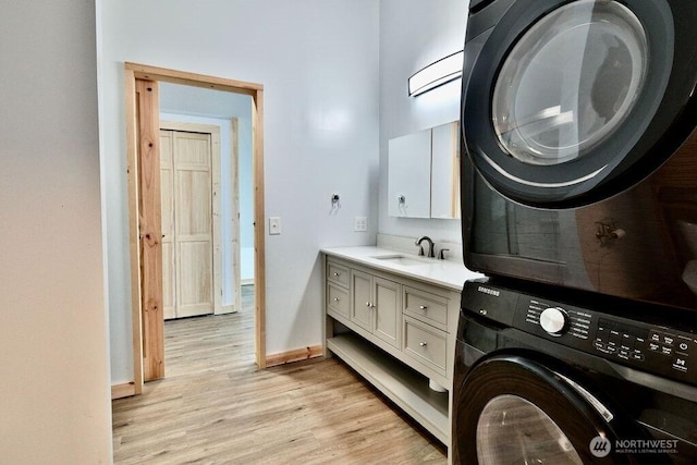 132 Milky Way, Sequim, WA 98382 - washroom featuring estacked washer and dryer and light wood-style flooring