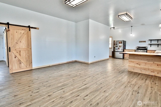 132 Milky Way, Sequim, WA 98382 - unfurnished living room with wood finished floors and a barn door