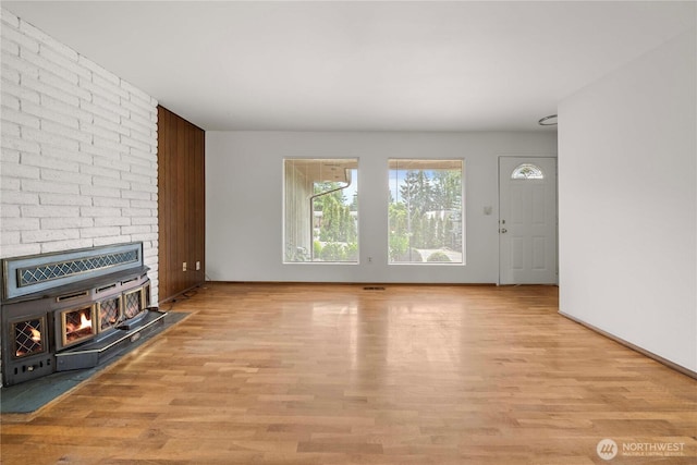 3824 S 176th St, Seatac, WA 98188 - unfurnished living room featuring wood finished floors and a wood stove