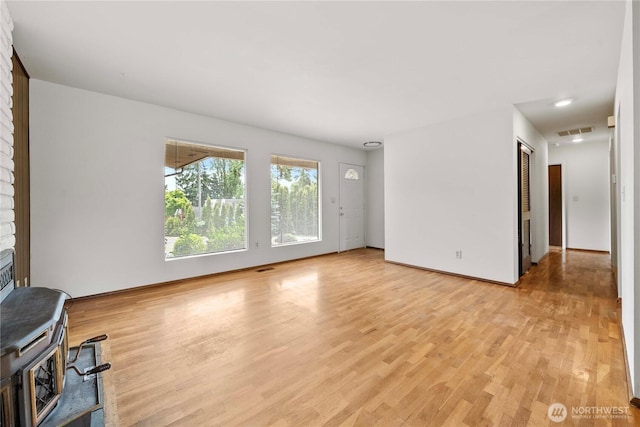 3824 S 176th St, Seatac, WA 98188 - unfurnished living room with light wood-style floors and a wood stove