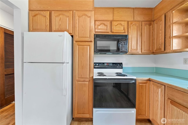 3824 S 176th St, Seatac, WA 98188 - kitchen featuring freestanding refrigerator, black microwave, electric stove, light countertops, and light wood-style flooring