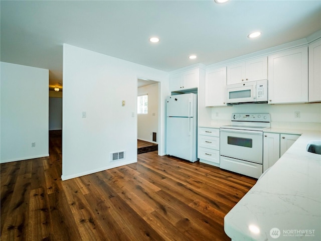 1804 SE 10th Ave, Olympia, WA 98501 - kitchen with white appliances, white cabinets, dark wood-style flooring, recessed lighting, and light stone countertops