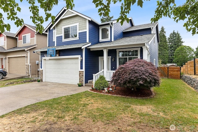 815 6th Ave SW, Olympia, WA 98512 - view of front facade featuring a garage, concrete driveway, and stone siding
