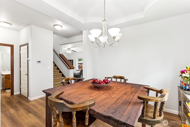 815 6th Ave SW, Olympia, WA 98512 - dining space with stairs, wood finished floors, a chandelier, and a ceiling fan