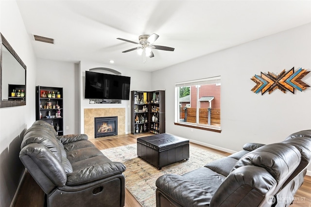815 6th Ave SW, Olympia, WA 98512 - living area featuring a ceiling fan, wood finished floors, and a tile fireplace