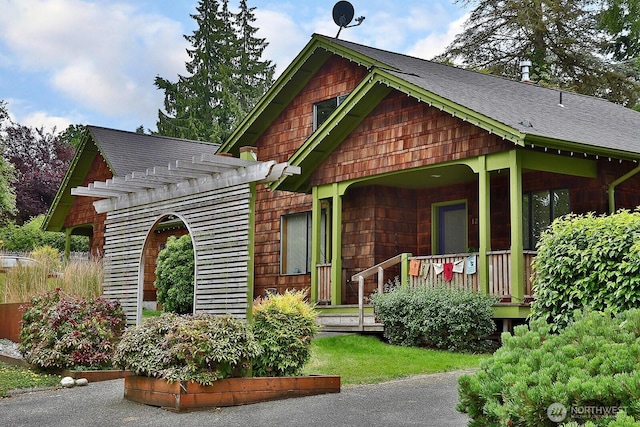 121 4th St, Langley, WA 98260 - view of front facade featuring covered porch, a pergola, and roof with shingles