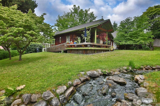 121 4th St, Langley, WA 98260 - rear view of property featuring a lawn and a deck