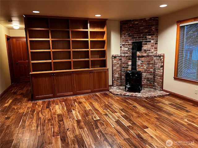121 4th St, Langley, WA 98260 - unfurnished living room with wood finished floors, a wood stove, and recessed lighting