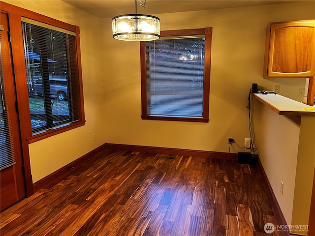 121 4th St, Langley, WA 98260 - unfurnished dining area with dark wood-style floors and a chandelier