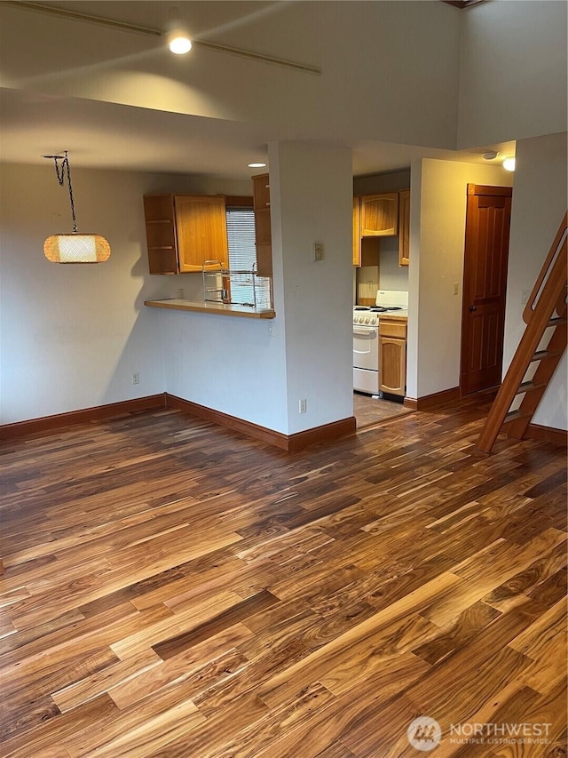 121 4th St, Langley, WA 98260 - unfurnished living room featuring dark wood-style flooring and stairs