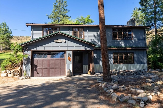 19834 State Route 20, Twisp, WA 98856 - view of front of house with a chimney, driveway, and a garage