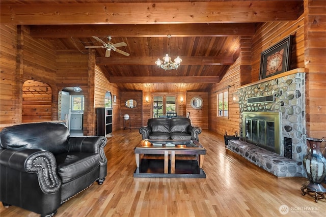 19834 State Route 20, Twisp, WA 98856 - living area with wooden walls, a wood ceiling with exposed beams, wood finished floors, a stone fireplace, and a ceiling fan