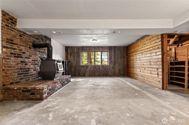 19834 State Route 20, Twisp, WA 98856 - unfurnished living room with a wood stove, unfinished concrete flooring, and wooden walls