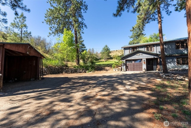 19834 State Route 20, Twisp, WA 98856 - view of home's exterior with a garage, dirt driveway, and an outbuilding