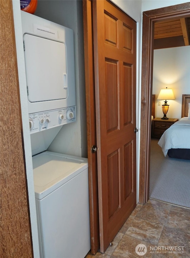 1407 Ocean Shores Blvd SW Unit 3N-H, Ocean Shores, WA 98569 - laundry area featuring stacked washing machine and dryer and light stone finish floors