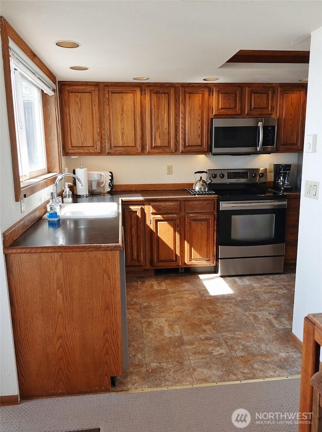 1407 Ocean Shores Blvd SW Unit 3N-H, Ocean Shores, WA 98569 - kitchen with stainless steel appliances and brown cabinetry