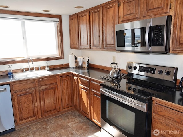 1407 Ocean Shores Blvd SW Unit 3N-H, Ocean Shores, WA 98569 - kitchen featuring stainless steel appliances, brown cabinets, recessed lighting, and dark countertops