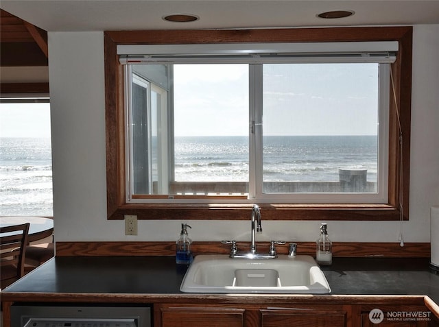 1407 Ocean Shores Blvd SW Unit 3N-H, Ocean Shores, WA 98569 - kitchen featuring dark countertops, dishwashing machine, and a water view