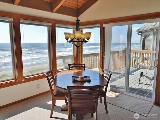 1407 Ocean Shores Blvd SW Unit 3N-H, Ocean Shores, WA 98569 - carpeted dining space with vaulted ceiling, a chandelier, and view of water and beach