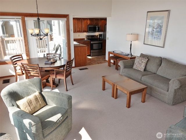 1407 Ocean Shores Blvd SW Unit 3N-H, Ocean Shores, WA 98569 - living room with a chandelier and light carpet