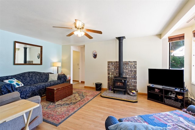 7717 176th Ave SW, Longbranch, WA 98351 - living area featuring a wood stove, a ceiling fan, and wood finished floors