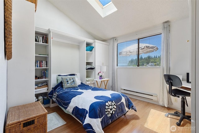 7717 176th Ave SW, Longbranch, WA 98351 - bedroom with a baseboard radiator, light wood finished floors, a skylight, and vaulted ceiling