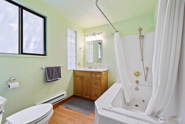 7717 176th Ave SW, Longbranch, WA 98351 - bathroom featuring a baseboard heating unit, a combined bath / shower with jetted tub, vanity, and wood finished floors