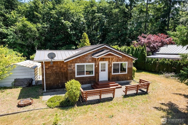7717 176th Ave SW, Longbranch, WA 98351 - view of front of home with a front yard and a metal roof